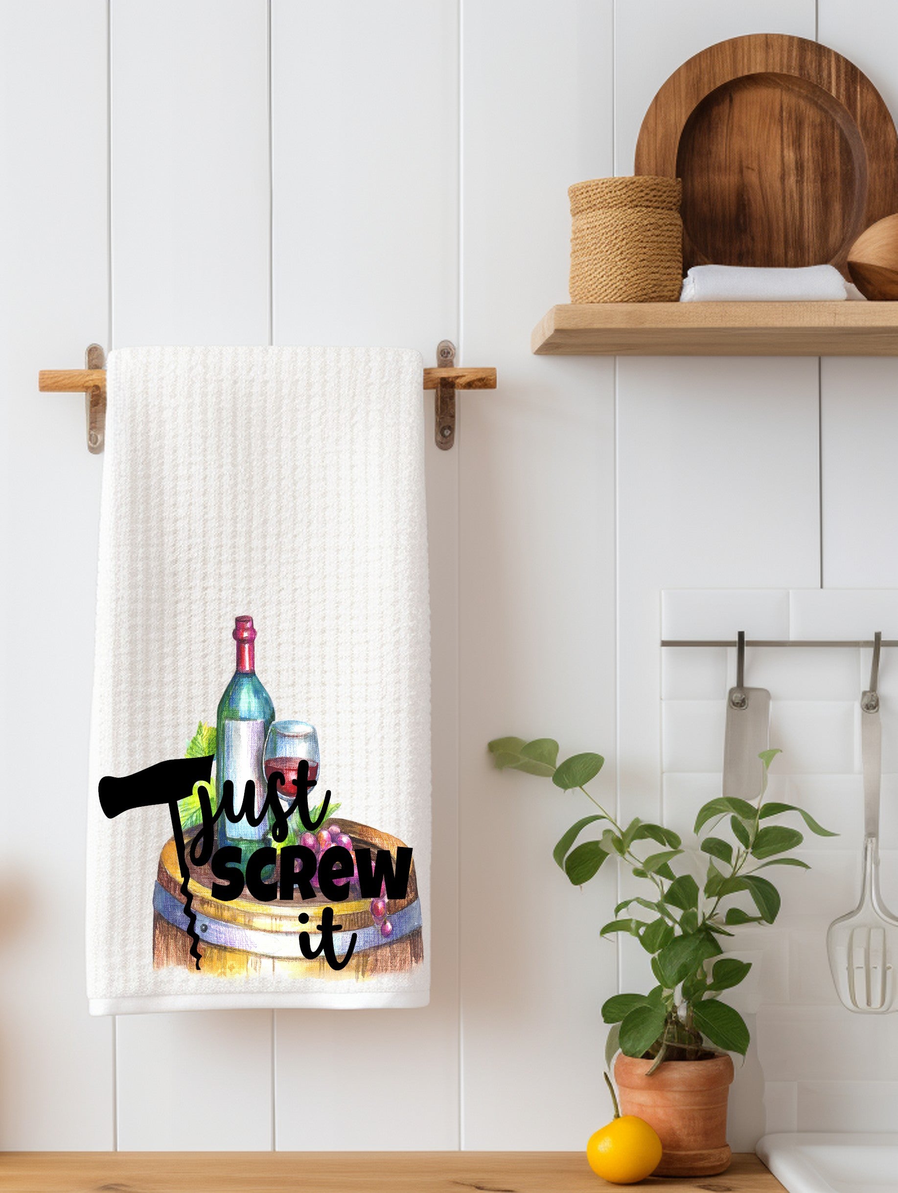 White kitchen towel with wine bottle, glass, and corkscrew graphic that reads 'Just screw it'