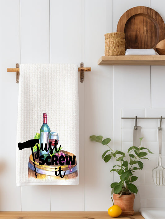 White kitchen towel with wine bottle, glass, and corkscrew graphic that reads 'Just screw it'